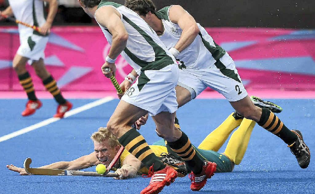 Matthew Butturini of Australia fights for the ball against Thorton McDade and Wade Paton of South Africa during the Men’s Hockey on Day 3 of the London Olympics. Matthew Butturini of Australia fights for the ball against Thorton McDade and Wade Paton of South Africa during the Men’s Hockey on Day 3 of the London Olympics.